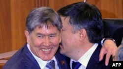 Newly elected prime minister of Kyrgyzstan, Almazbek Atambaev (L), is congratulated by the newly elected parliament speaker Akhmatbek Keldibekov. 