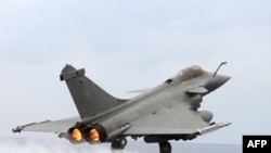 A French Navy fighter jet takes off from the "Charles de Gaulle" aircraft carrier in the Mediteranean early in NATO's campaign to protect civilians in Libya.