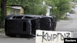 "Kyrgyz Zone" is spray-painted on a concrete block in the middle of a street in Osh on June 13.