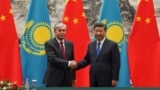 Chinese President Xi Jinping (right) shakes hands with Kazakh President Qasym-Zhomart Toqaev at the end of a signing ceremony at the Great Hall of the People in Beijing on September 11, 2019.