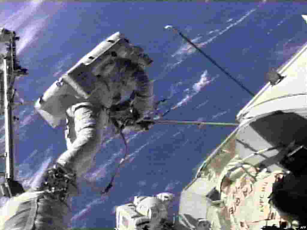 U.S. space shuttle &quot;Endeavour&quot; crew member Jim Newman (left) works at freeing a sticking antenna on the &quot;Zarya&quot; module of the International Space Station as crew member Jerry Ross (center) looks on. This was one of the ISS&#39;s first early hiccups, but was resolved successfully. 