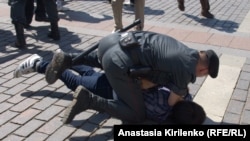 Russian security forces detain one of the participants in a gay-pride rally in Moscow on May 28.