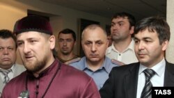 Chechen leader Ramzan Kadyrov at a June meeting with Ingushetia's acting President Rashid Gaysanov (right)