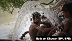 Pakistani boys cool off in a canal amid sweltering heat in Karachi. (file photo)