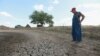 Farmer Marion Kujawa looks over a pond he usually uses to water the cattle on his farm in Ashley, Illinois. According to the Illinois Farm Bureau, the state is experiencing the sixth-driest year on record.