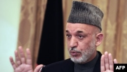 Afghan President Hamid Karzai addresses a press conference at the presidential palace in Kabul on November 23.