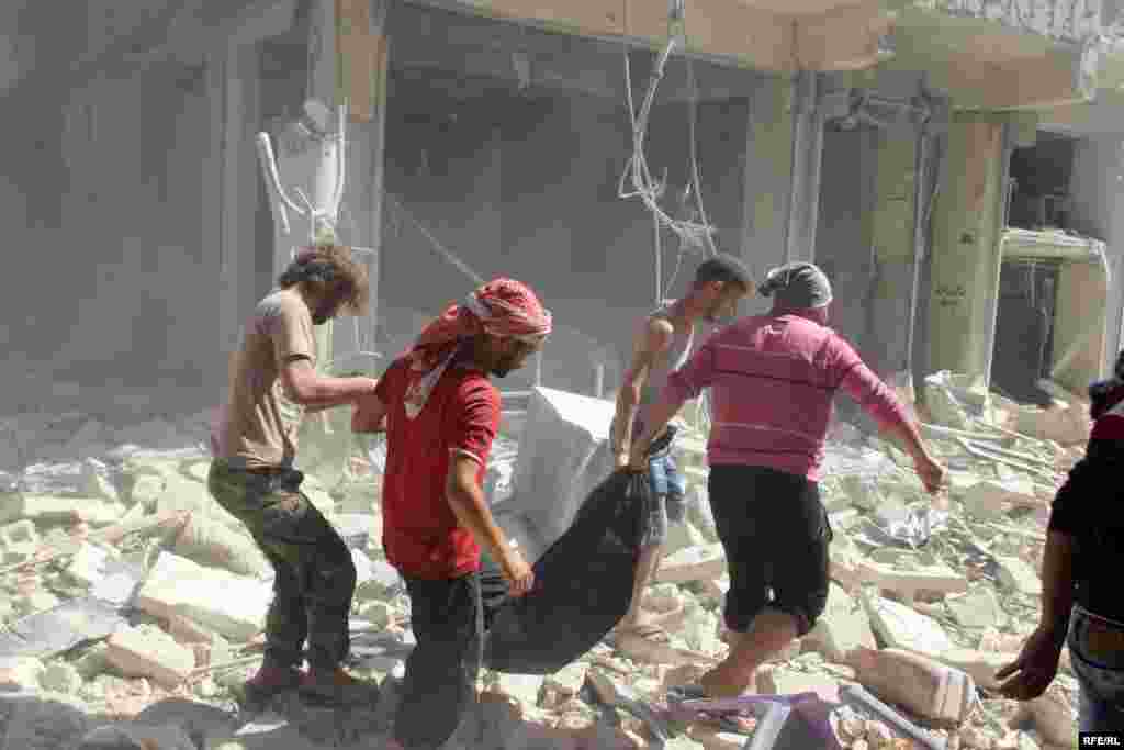 Civilians pull a body from the remains of a shattered building&nbsp;in Aleppo&#39;s Bustan al-Qasr district on October 11.&nbsp;