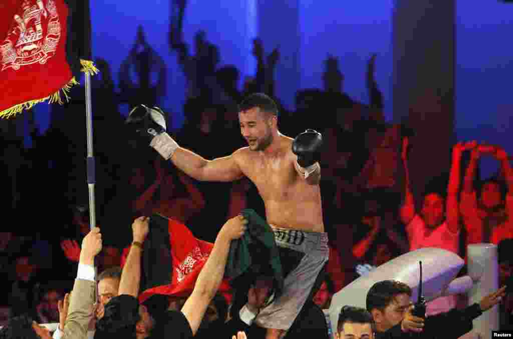 Hamid Rahimi celebrates his victory over Said Mbelwa (not pictured) after their World Boxing Organization intercontinental middleweight fight in Kabul.