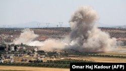 Smoke billows during reported Syrian government shelling of the village of Sheikh Mustafa in the rebel-held Idlib Province.