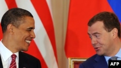 Barack Obama and Dmitry Medvedev are all smiles as they sign a nuclear disarmament treaty in Prague.