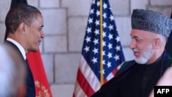 Afghan President Hamid Karzai (right) shakes hands with U.S. President Barack Obama after signing the accord in Kabul.