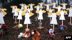 Twenty seven wooden angels stand in a yard down the street from the Sandy Hook School in Newtown, Connecticut, as a mark of respect for the massacre that occurred there on December 14. 