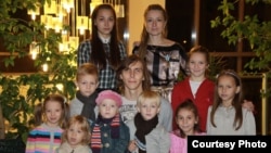 This photo from 2010 shows Katsyaryna Onakhava (top right) and her husband Alyaksandr (middle), along with two biological and seven adopted or foster children.