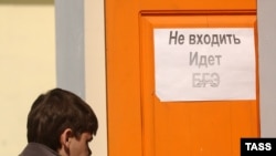 A student in Chita enters the examination hall.