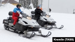 Russian President Vladimir Putin (left) and his Belarusian counterpart Alyaksandr Lukashenka ride snowmobiles following their talks in Sochi on February 22. 