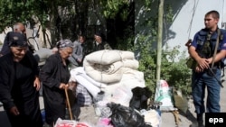 Georgians with their belongings wait to be evacuated by the Russian Emergency Situations Ministry from the village of Kurta, near Tskhinvali, South Ossetia, in August 2008.