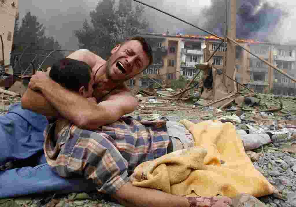 A Georgian man cries as he holds the body of a loved one after a Russian bombardment on August 9 in Gori, Georgia, near the border of the breakaway region of South Ossetia.