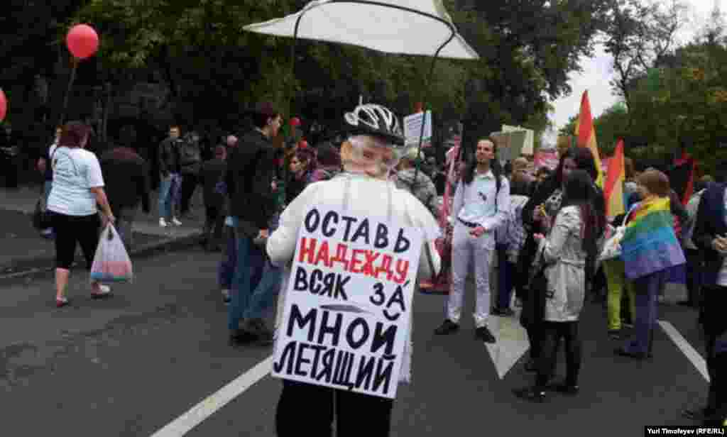 In a reference to Putin&#39;s recent escapade flying an ultralight aircraft to try and teach young cranes how to migrate, this woman&#39;s sign reads: &quot;Abandon hope anyone flying behind me.&quot;