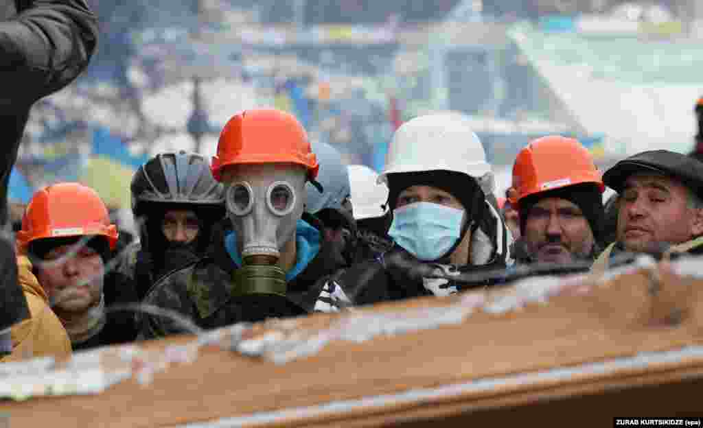 Pro-European protesters stand on a barricade built to block the way to Independence Square in Kyiv on&nbsp;December 9.