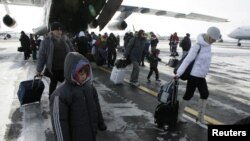 Russian citizens who were evacuated from Libya leave a plane owned by the Emergency Situations Ministry at Domodedovo airport outside Moscow.