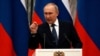 Russian President Vladimir Putin gestures during a press conference with French President Emmanuel Macron in Moscow on February 7.