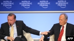 Recep Tayyip Erdogan (left) took exception to getting cut off in his reponse to Shimon Peres in Davos.