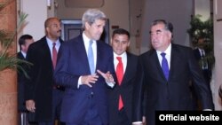 U.S. Secretary of State Jon Kerry (left) speaks with Tajik President Emomali Rahmon in Dushanbe on November 3.