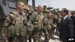 French President Francois Hollande reviews troops during his visit to a military base in Kapisa Province, Afghanistan on May 25.