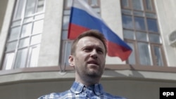 Anticorruption blogger and opposition leader Aleksei Navalny speaks to journalists in front of the Lyublinsky district court in Moscow on April 23.