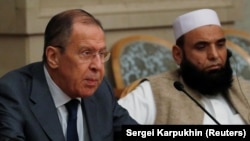 Russian Foreign Minister Sergei Lavrov (left) and Taliban delegate Alhaj Mohammad Sohail Shaina take part in multilateral peace talks on Afghanistan in Moscow in November 2018. 