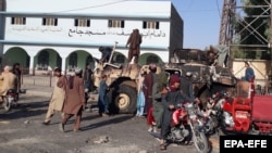 Taliban militants gather after taking control of Lashkar Gah, the provincial capital of Helmand on August 13.