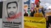 Iranian opposition activists protest with a poster depicting Iranian official Asadollah Assadi in Brussels in October 2018.