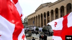 Opposition supporters rally outside the parliament building in Tbilisi on April 17.