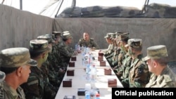 Azerbaijani President Ilham Aliyev (center) talks to soldiers serving in the Agdam district east of Nagorno-Karabakh on August 6.