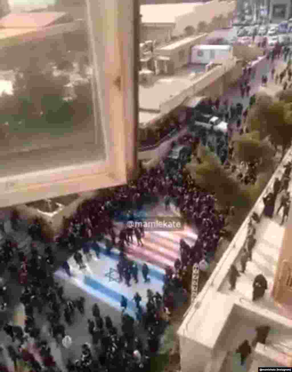 Protesters avoided stepping on the U.S. and Israeli flags while gathering at Beheshti University campus on January 12. Just nine days earlier, other angry crowds were seen burning those flags after Iranian military commander Qasem Soleimani was assassinated by a U.S. drone strike in Iraq.&nbsp;