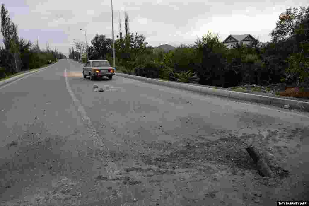 An unexploded artillery shell on a road on the outskirts of the Azerbaijani city of Tartar