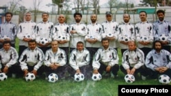 Mohammad Isaq (top right) poses with members of the Sabawoon 1999 soccer team at Ghazi Stadium in Kabul.