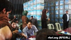 The auditors review ballots from the presidential election runoff at the Independent Election Commission office in Kabul on July 18.