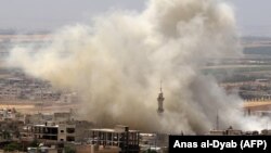 Smoke plumes follow reported air strikes on the town of Khan Sheikhun in the southern countryside of the rebel-held Idlib Province on June 3.