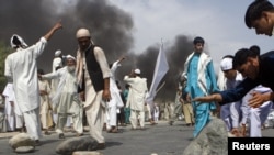 Protesters tried to set up makeshift barricades Nangarhar Province on September 10, the first day of Afghan demonstrations against the Florida pastor's Koran-burning plans.