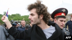 A Russian police officer arrests a participant in the gay rights protest in Moscow.