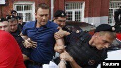 Policemen detained opposition leader and anticorruption blogger Aleksei Navalny (center) after he visited the city's election commission office on July 10 to submit documents to register as a mayoral election candidate in Moscow.