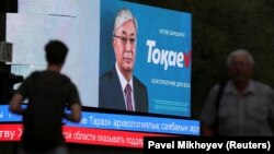 Interim Kazakh President Qasym-Zhomart Toqaev is seen on an electronic election billboard.