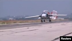 An image from video footage released by Russia's Defense Ministry on October 5 shows a Russian Air Force Su-24 military jet slowing down after a sortie at Heymim air base in Syria.