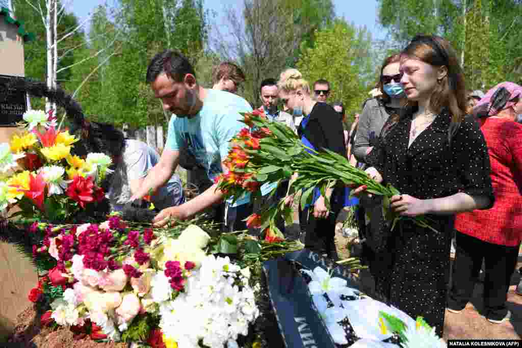 Mourners lay flowers at the grave of English teacher Elvira Ignatyeva, who was killed during a shooting at School No. 175, during her funeral in Kazan on May 12.