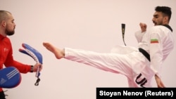 Iranian tae kwon do competitor Farzad Zolghadri practices with Bulgarian national tae kwon do coach Teodor Georgiev during a training session in Sofia on January 30.