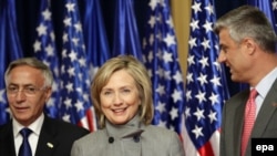 Prime Minister Hashim Thaci (right) and acting President Jakup Krasniqi welcome U.S. Secretary of State Hillary Clinton to Pristina on October 13.