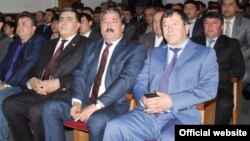 Interior Minister Ramazon Rahimzoda (right) is apparently no stranger to writing.