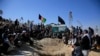 Afghan men bury a victim of the October 24 suicide attack that targeted an education center in Kabul.