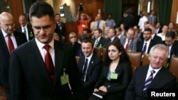 Serbia's Foreign Minister Vuk Jeremic (second from the left) arrives at the International Court of Justice at the Peace Palace in The Hague as Kosovo's Foreign Minister Skender Hyseni (right) looks on July 22.